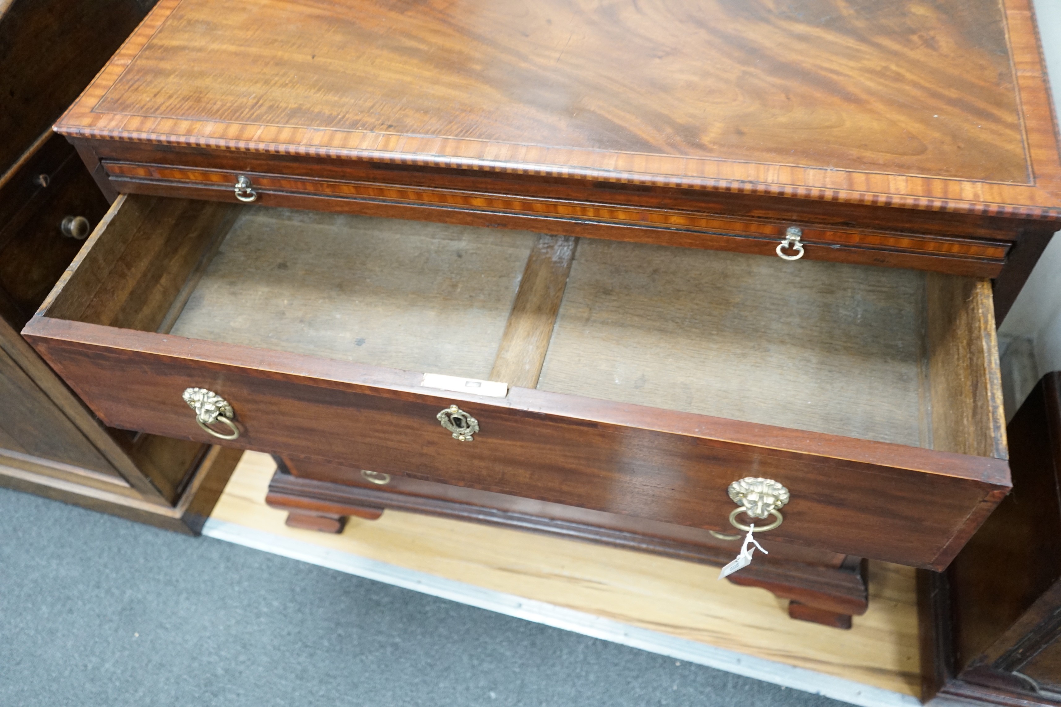 A George III and later banded mahogany chest of three drawers with brushing slide, width 85cm, depth 49cm, height 81cm *Please note the sale commences at 9am.